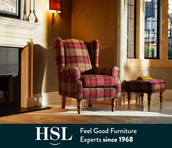 A wingback HSL chair in a red and taupe fabric, designed for posture support.